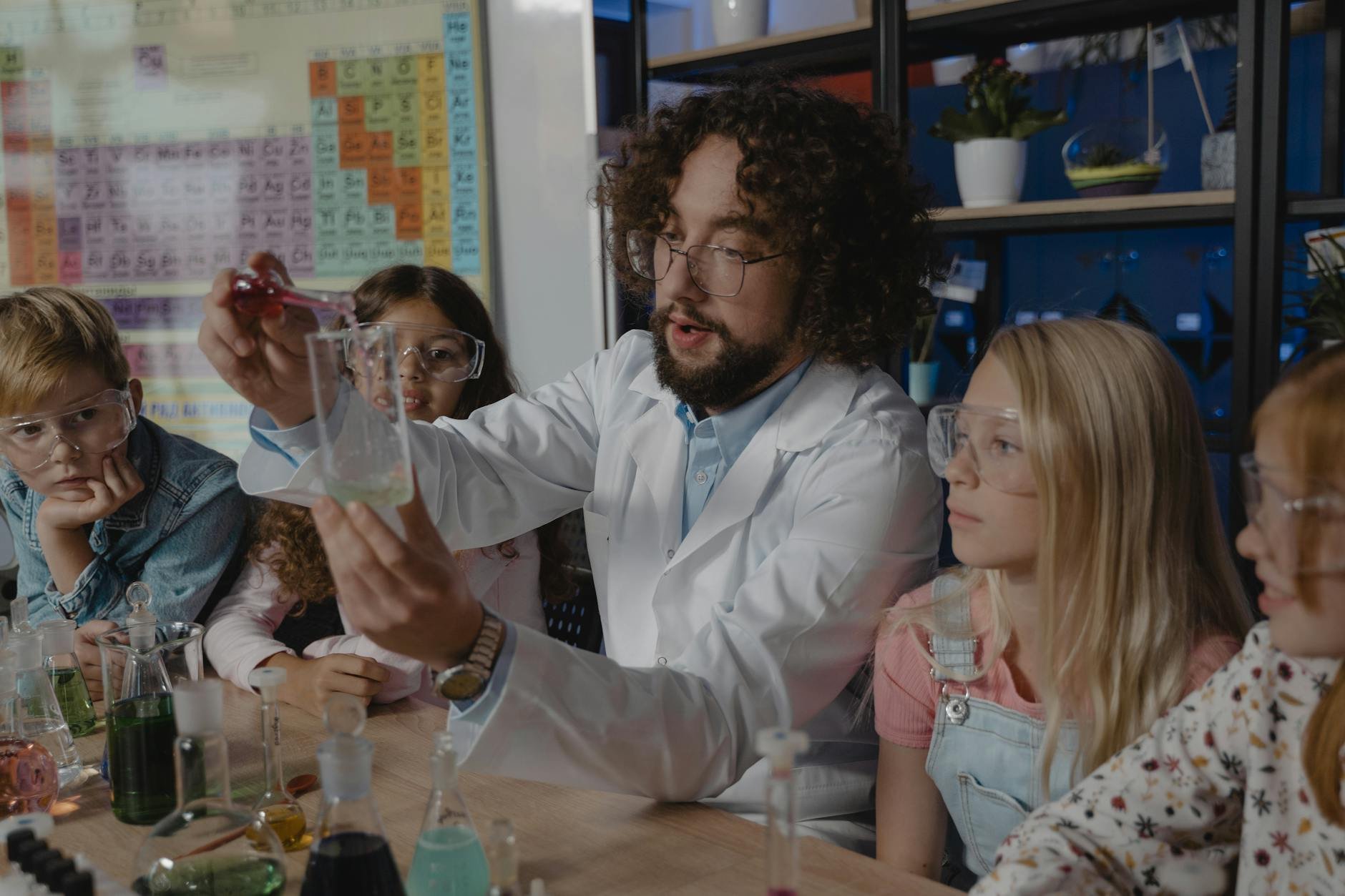 A person in a lab coat illustrating the science of cleaning chemicals